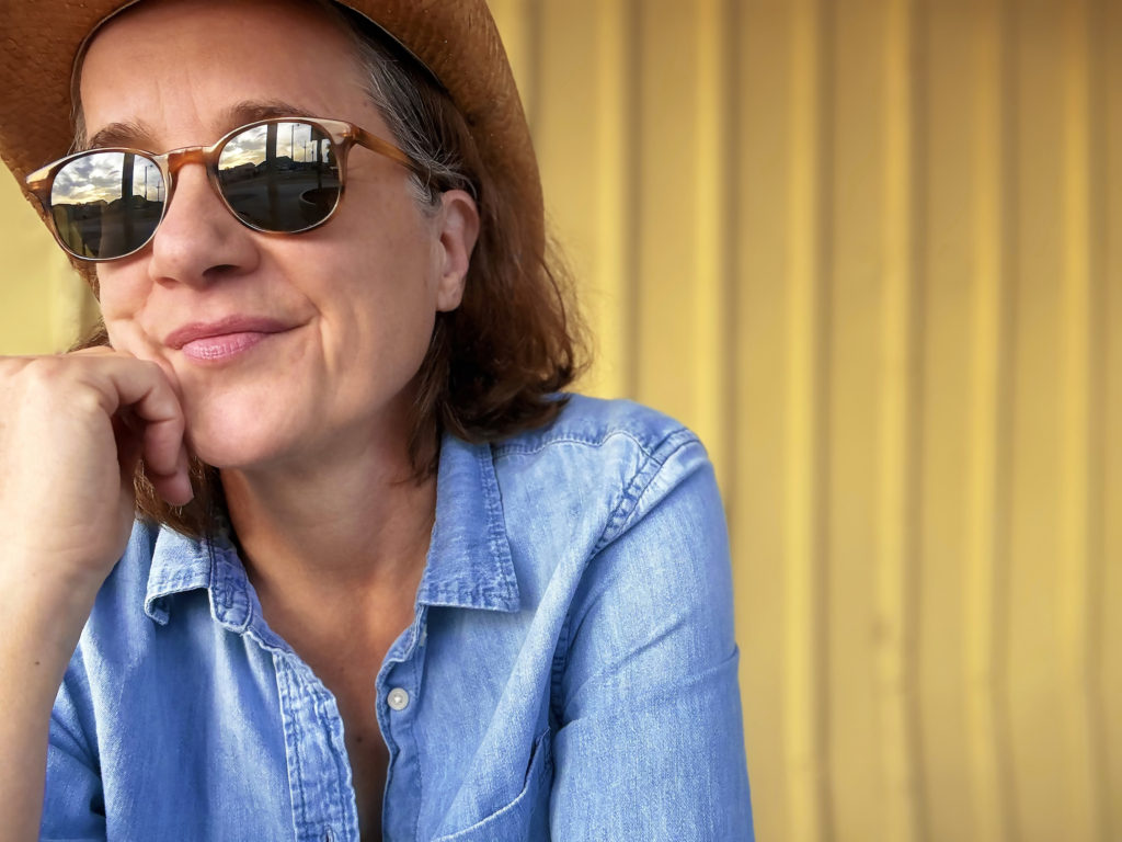 Susan Werner looking off into the distance wearing sunglasses and a blue shirt Promo Shot for Halfway to Houston in RGB format