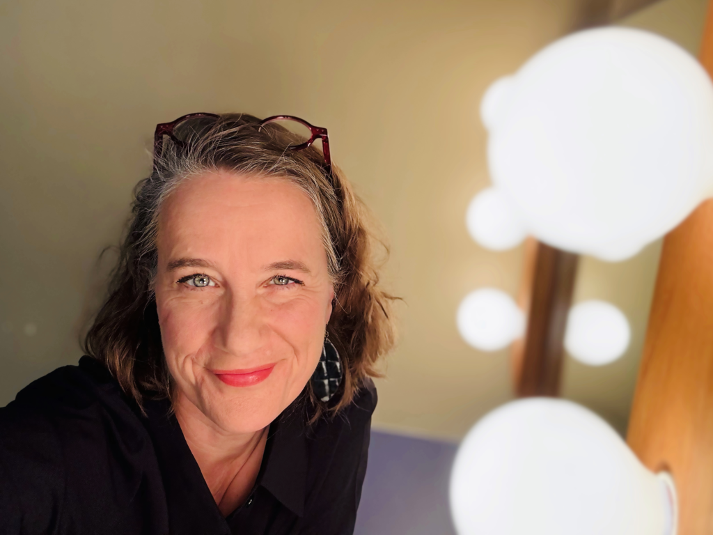 Susan Werner in a dressing room looking directly at camera